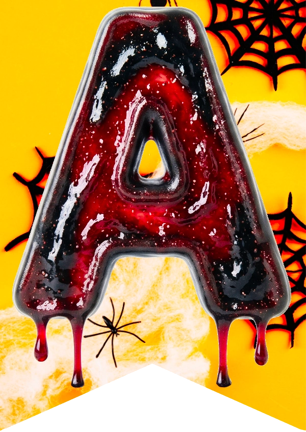 A glossy, dripping letter A candle or decorative letter in a dark red and black marbled design, set against a bright yellow Halloween-themed background with spiderwebs and a spider.