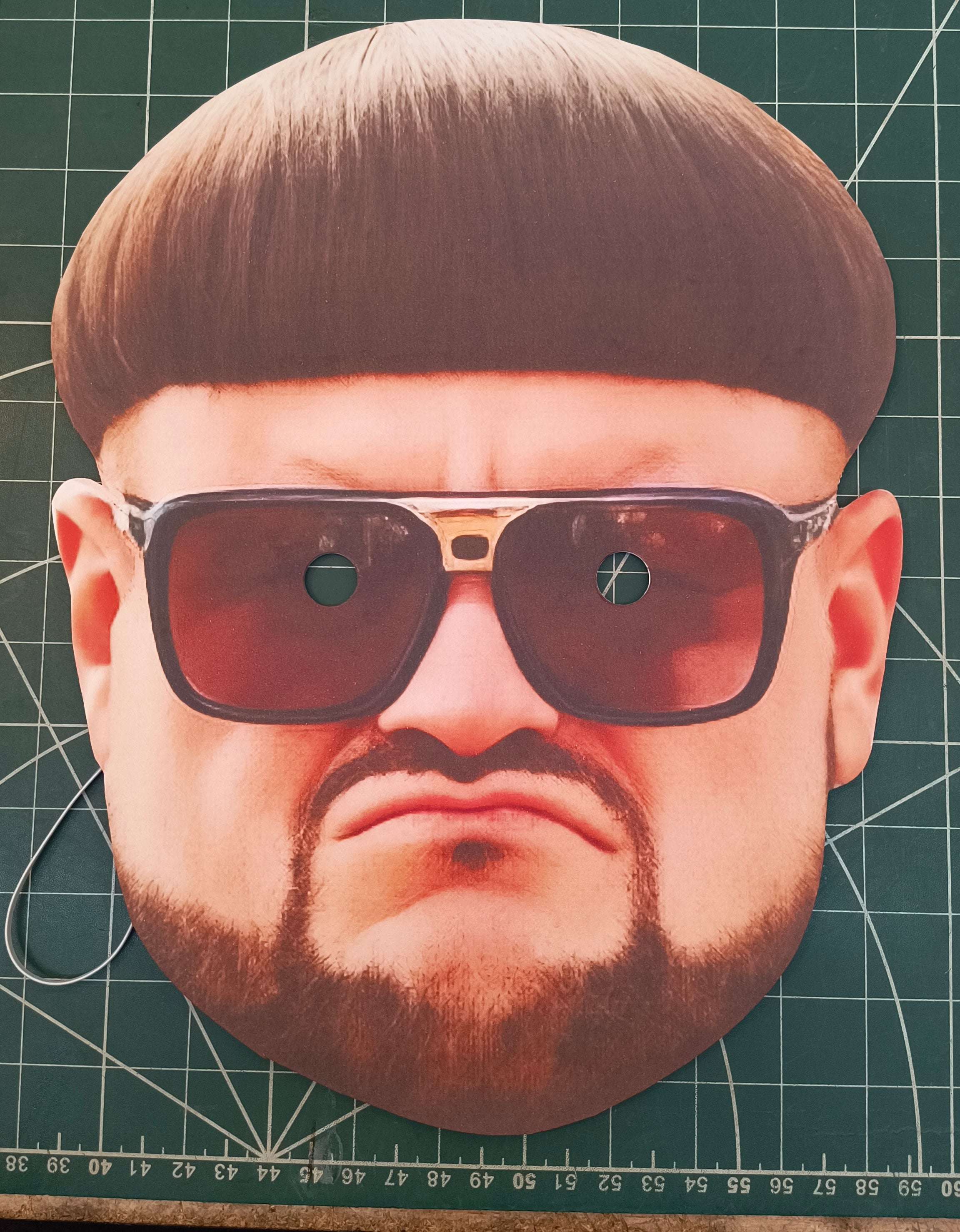 Cardboard cutout of ibiza boss with sunglasses and a hairstyle on a grid background